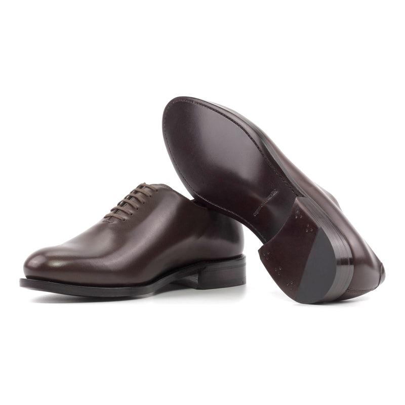 One Cut en cuir marron foncé, semelle cuir : une chaussure debout, l’autre couchée qui montre sa semelle