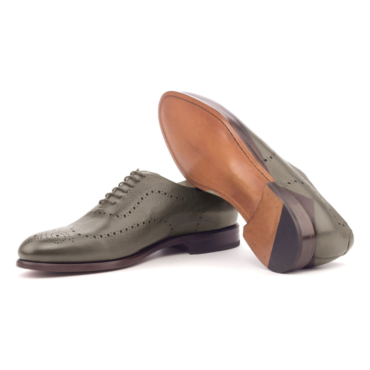 One Cut perforé en cuir grainé gris, semelle cuir : une chaussure debout, l’autre couchée montre sa semelle